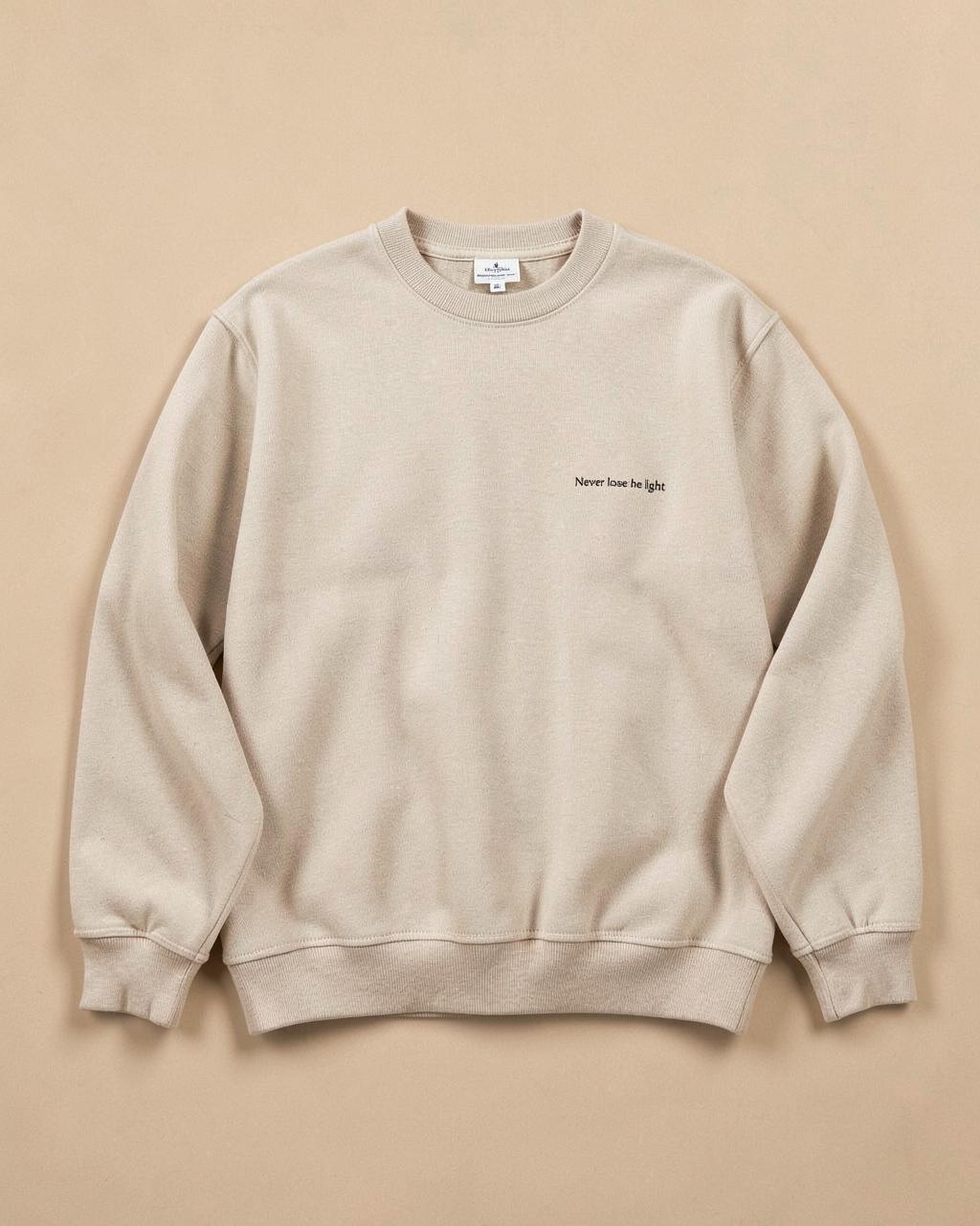Beige Never Lose the Light sweatshirt flat lay