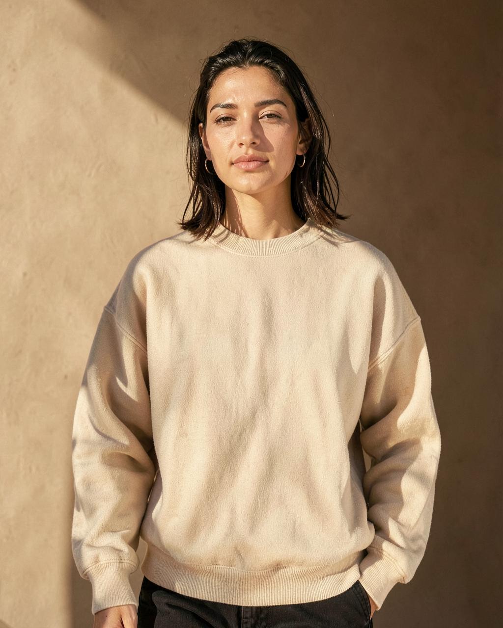 Model wearing the beige Never Lose the Light sweatshirt