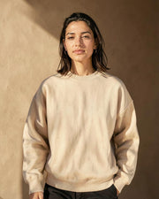 Model wearing the beige Never Lose the Light sweatshirt