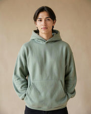Model wearing the sage Locked In hoodie